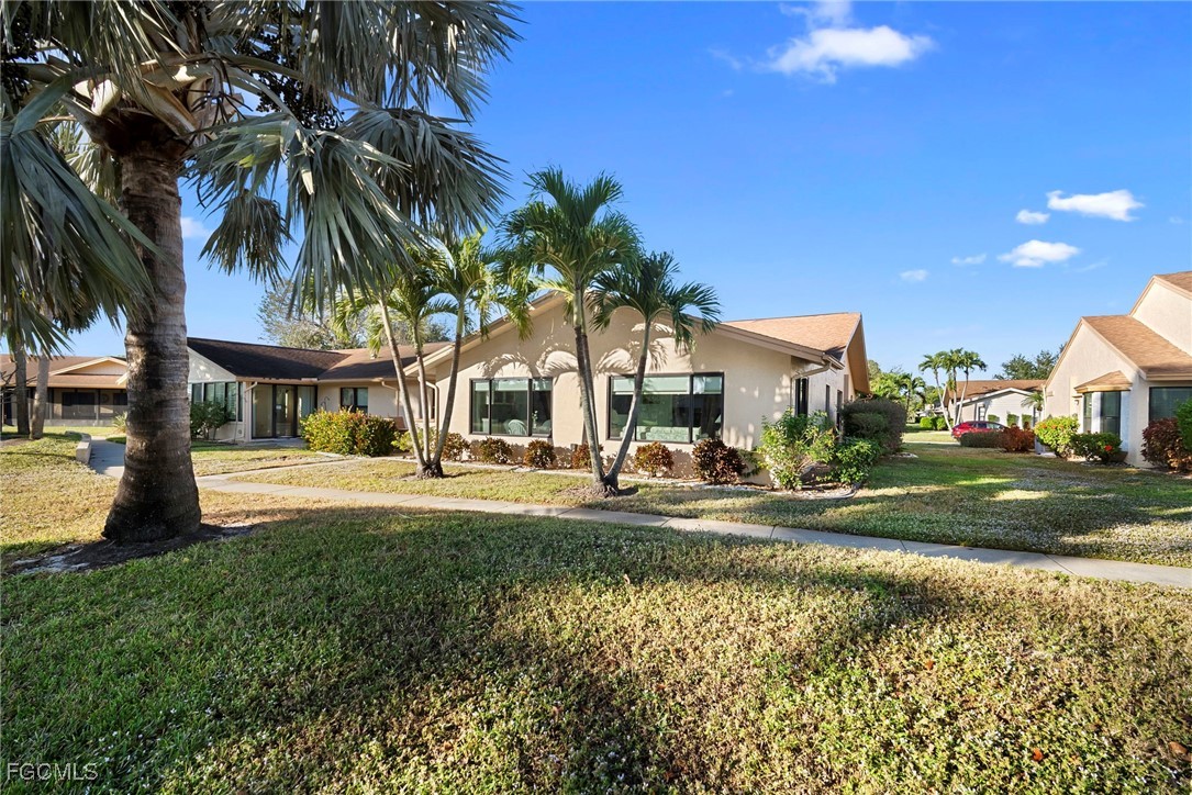 5688 Arvine Circle Fort Myers, FL 33919 - Photo 38 of 39 a front view of a house with a yard table and chairs