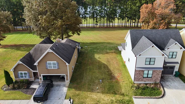 an aerial view of a house with a yard