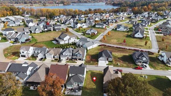 an aerial view of a house with a lake view