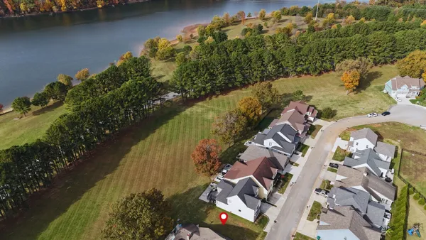 an aerial view of a house with a lake view