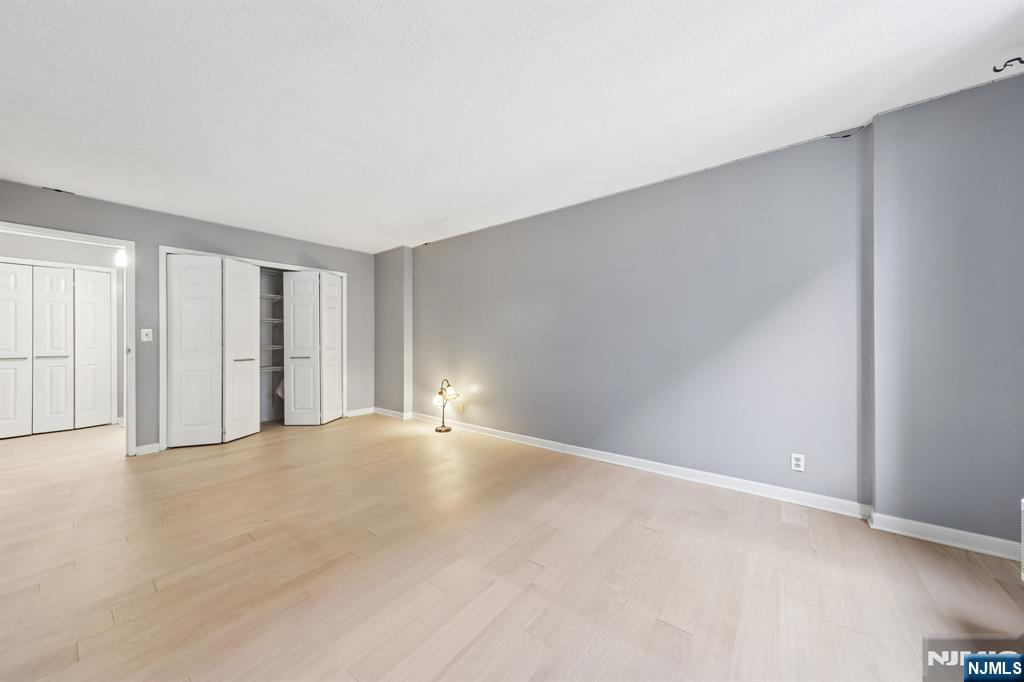 326 Prospect Avenue, Unit 10H Hackensack, NJ 07601 - Photo 12 of 31 a view of an empty room with wooden floor