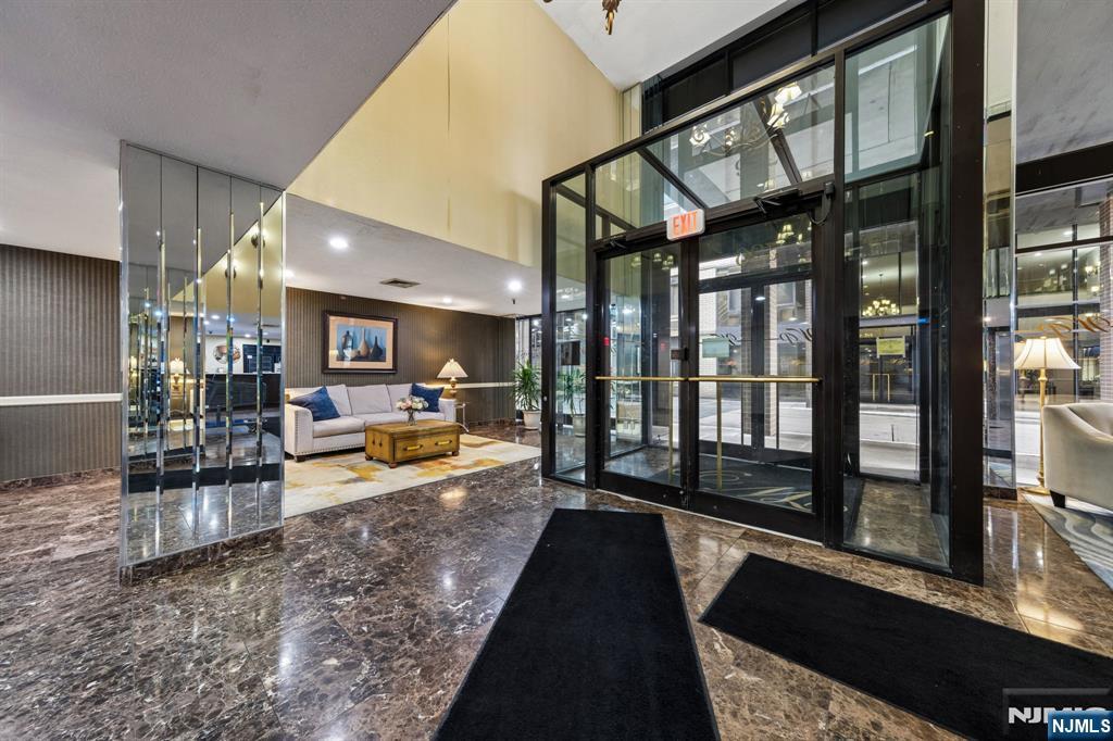 326 Prospect Avenue, Unit 10H Hackensack, NJ 07601 - Photo 27 of 31 a swimming pool with outdoor seating and a garden