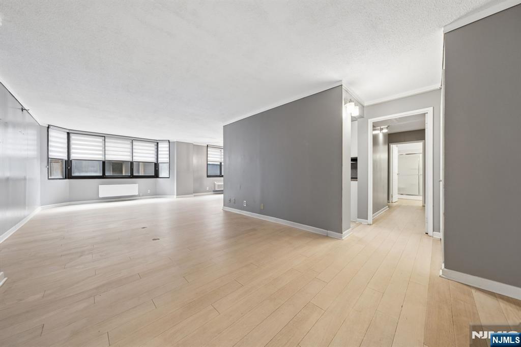 326 Prospect Avenue, Unit 10H Hackensack, NJ 07601 - Photo 6 of 31 a view of a big room with windows and chandelier fan
