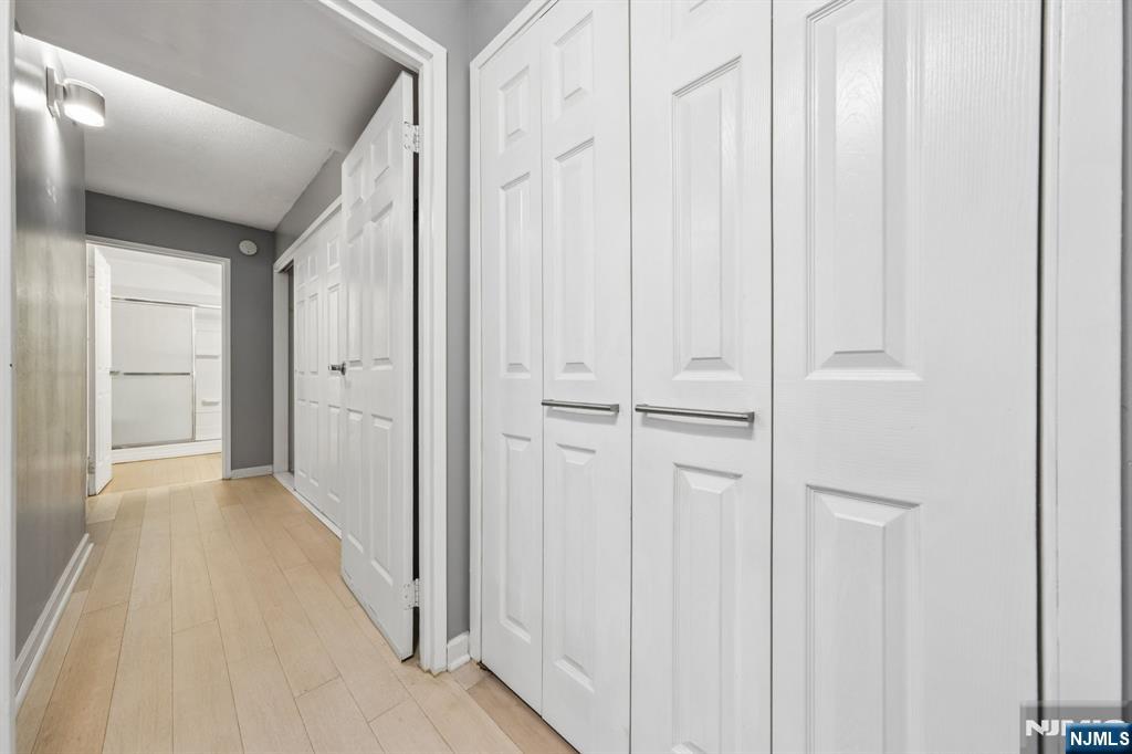 326 Prospect Avenue, Unit 10H Hackensack, NJ 07601 - Photo 9 of 31 a view of a hallway with wooden floor