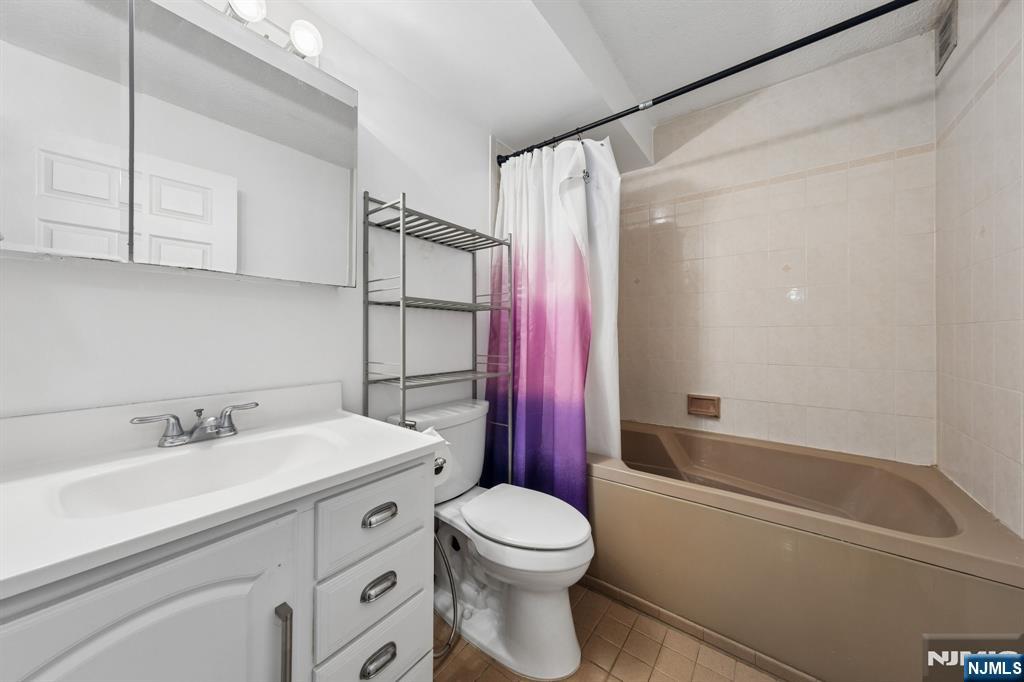 326 Prospect Avenue, Unit 10H Hackensack, NJ 07601 - Photo 10 of 31 a bathroom with a sink a toilet and a bathtub