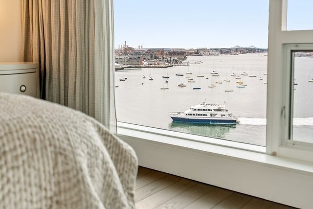 a view of a living room with a bed and a window