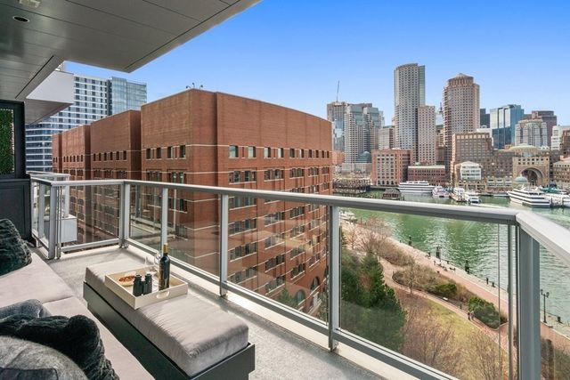 a balcony with a bench and lake view