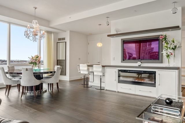 a living room with furniture a fireplace and a dining table