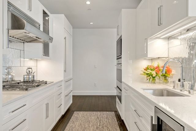 a kitchen with a sink stove and refrigerator