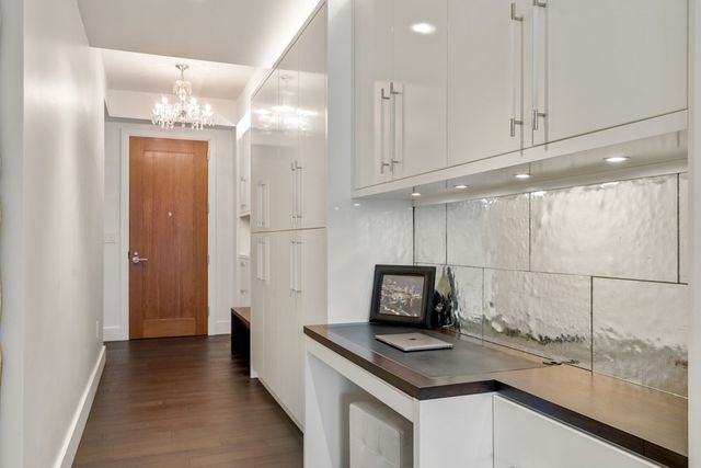 a kitchen with a sink cabinets and wooden floor