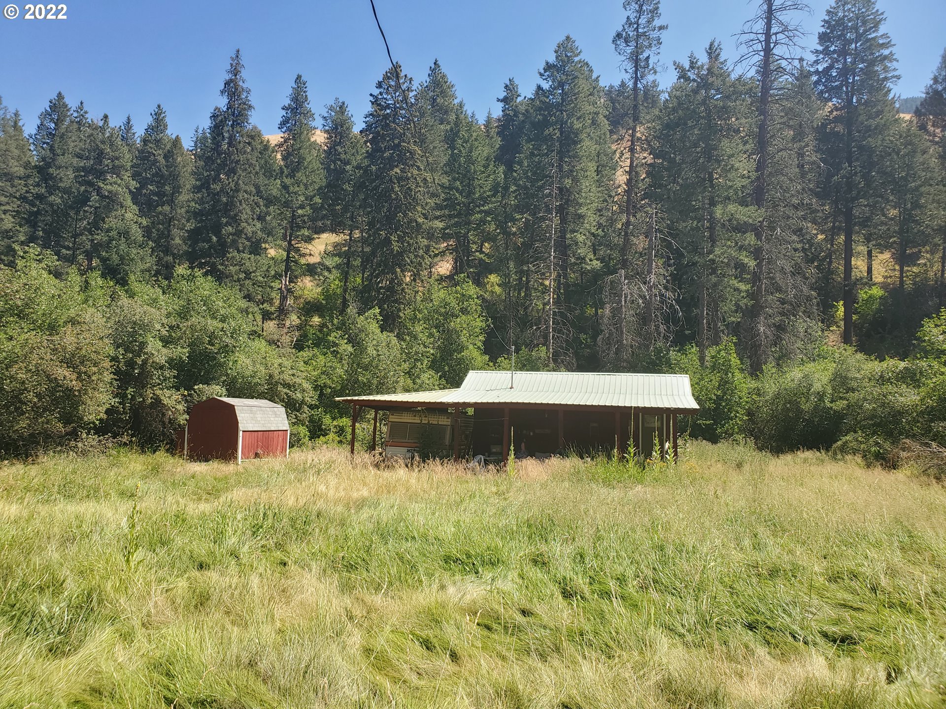 60310 Elk Way Imnaha, OR 97842 - Photo 18 of 19 a view of a lake with a house in the background