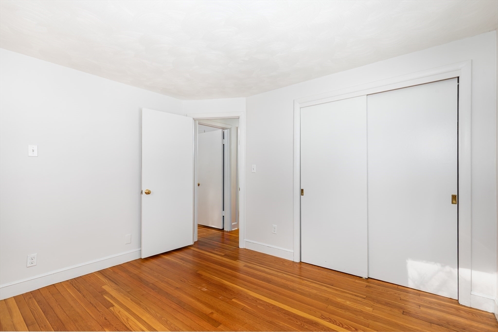 24 Pomeroy Road, Unit 24 North Reading, MA 01864 - Photo 11 of 21 a view of an empty room with wooden floor