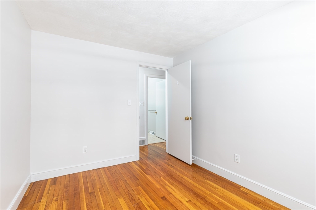 24 Pomeroy Road, Unit 24 North Reading, MA 01864 - Photo 13 of 21 a view of an empty room with wooden floor