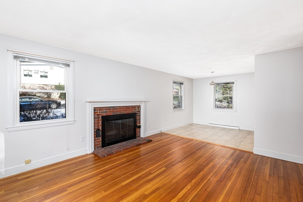 24 Pomeroy Road, Unit 24 North Reading, MA 01864 - Photo 2 of 21 an empty room with windows and fireplace