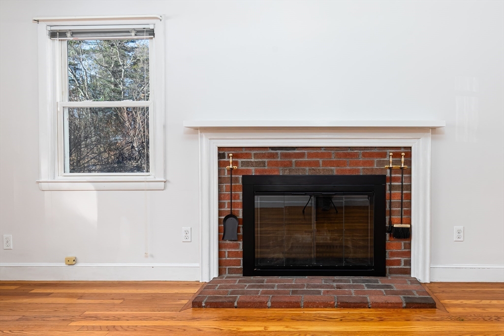 24 Pomeroy Road, Unit 24 North Reading, MA 01864 - Photo 3 of 21 a living room with a fireplace and a window