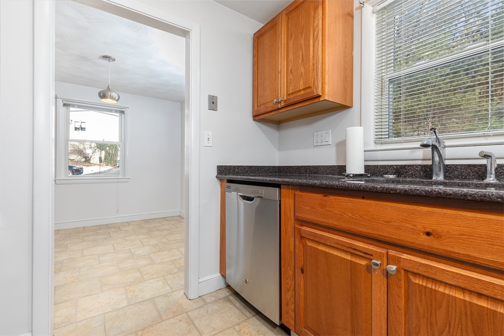 24 Pomeroy Road, Unit 24 North Reading, MA 01864 - Photo 7 of 21 a kitchen with granite countertop cabinets and window