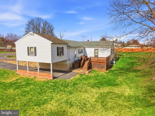 a aerial view of a house next to a big yard and large trees