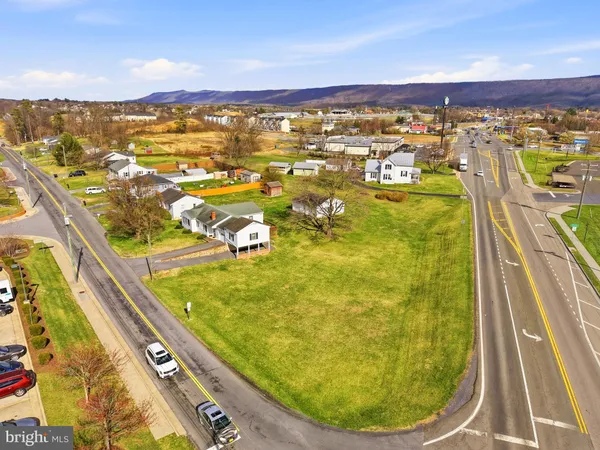 a view of a city with an ocean and houses