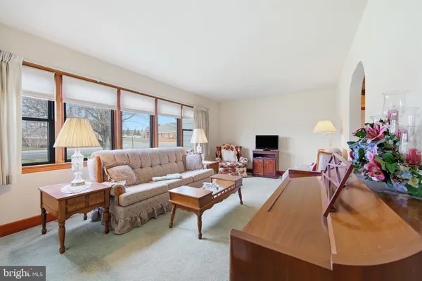 a kitchen with a table chairs sink and cabinets