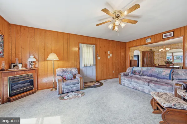 a view of a dining room with furniture and a chandelier