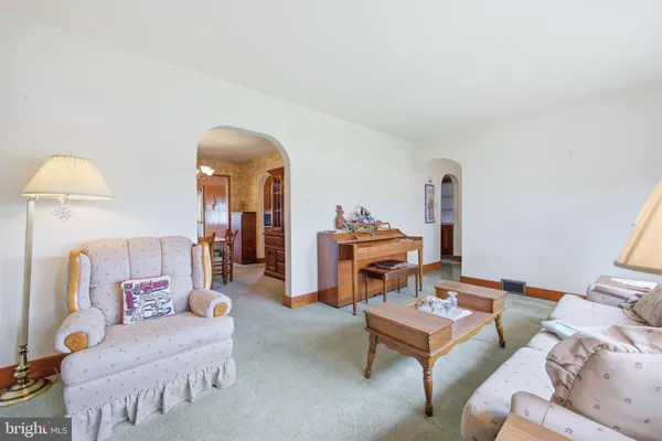 a spacious bedroom with a bed and a chandelier