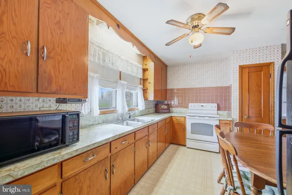 a bathroom with a sink a toilet a shower and a mirror
