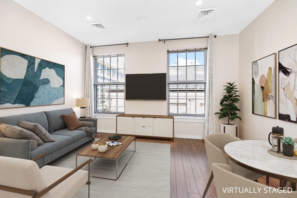 45 1st Avenue, Unit 406 Boston, MA 02129 - Photo 1 of 13 a living room with furniture and a flat screen tv