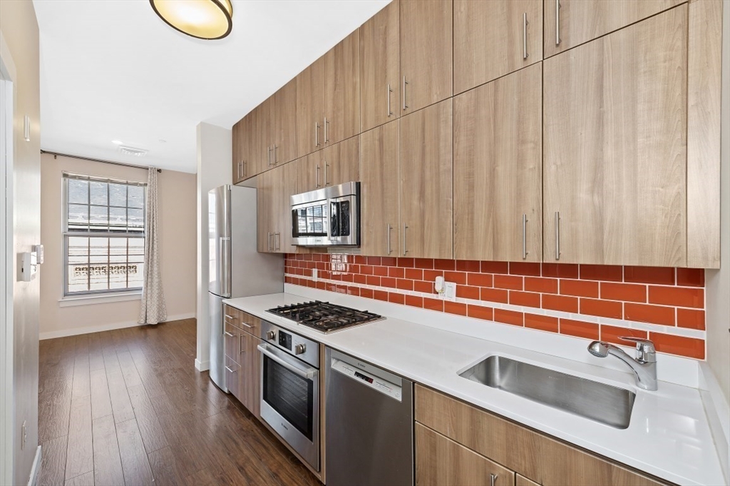 45 1st Avenue, Unit 406 Boston, MA 02129 - Photo 3 of 13 a kitchen that has a sink a stove and wooden floor
