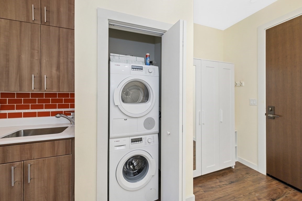 45 1st Avenue, Unit 406 Boston, MA 02129 - Photo 4 of 13 a view of a storage & utility room with dryer and washer