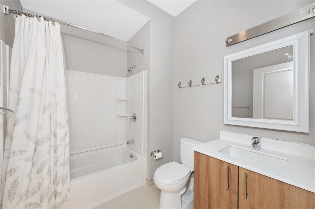 45 1st Avenue, Unit 406 Boston, MA 02129 - Photo 6 of 13 a bathroom with a sink toilet a mirror and shower
