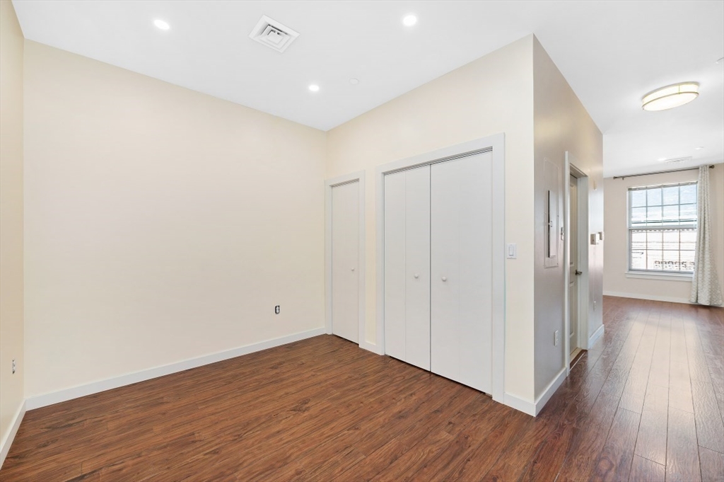 45 1st Avenue, Unit 406 Boston, MA 02129 - Photo 9 of 13 a view of empty room with wooden floor and fan