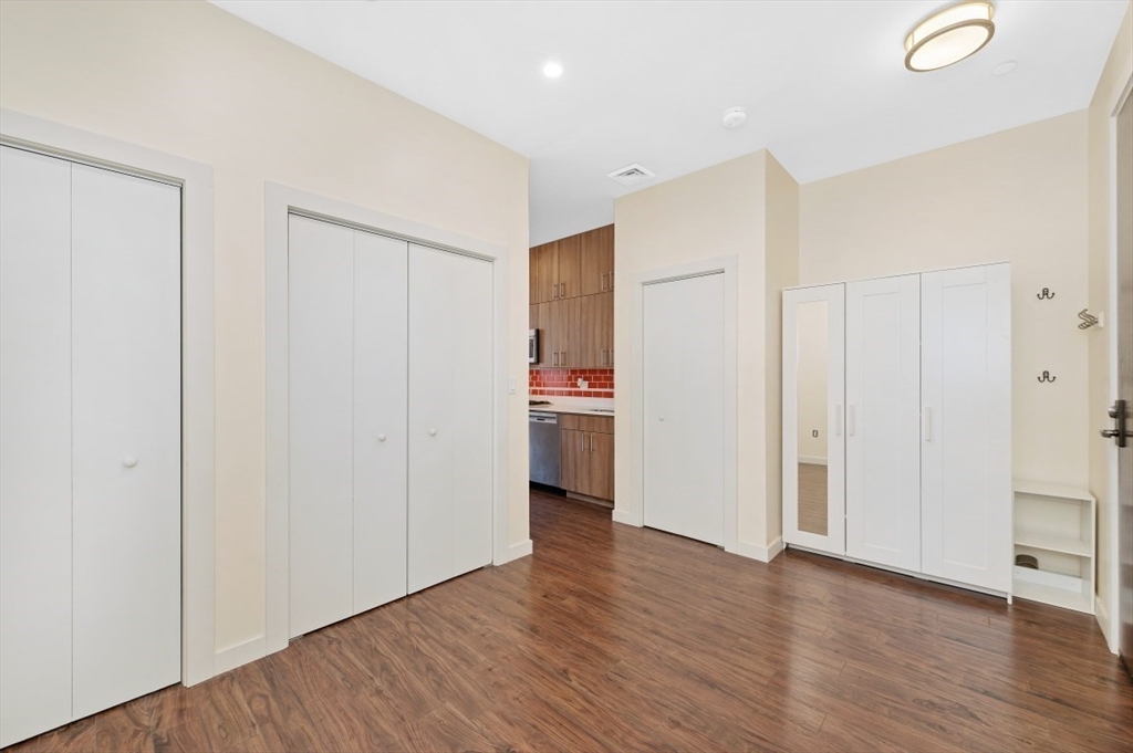 45 1st Avenue, Unit 406 Boston, MA 02129 - Photo 10 of 13 a view of a kitchen with wooden floor and a refrigerator
