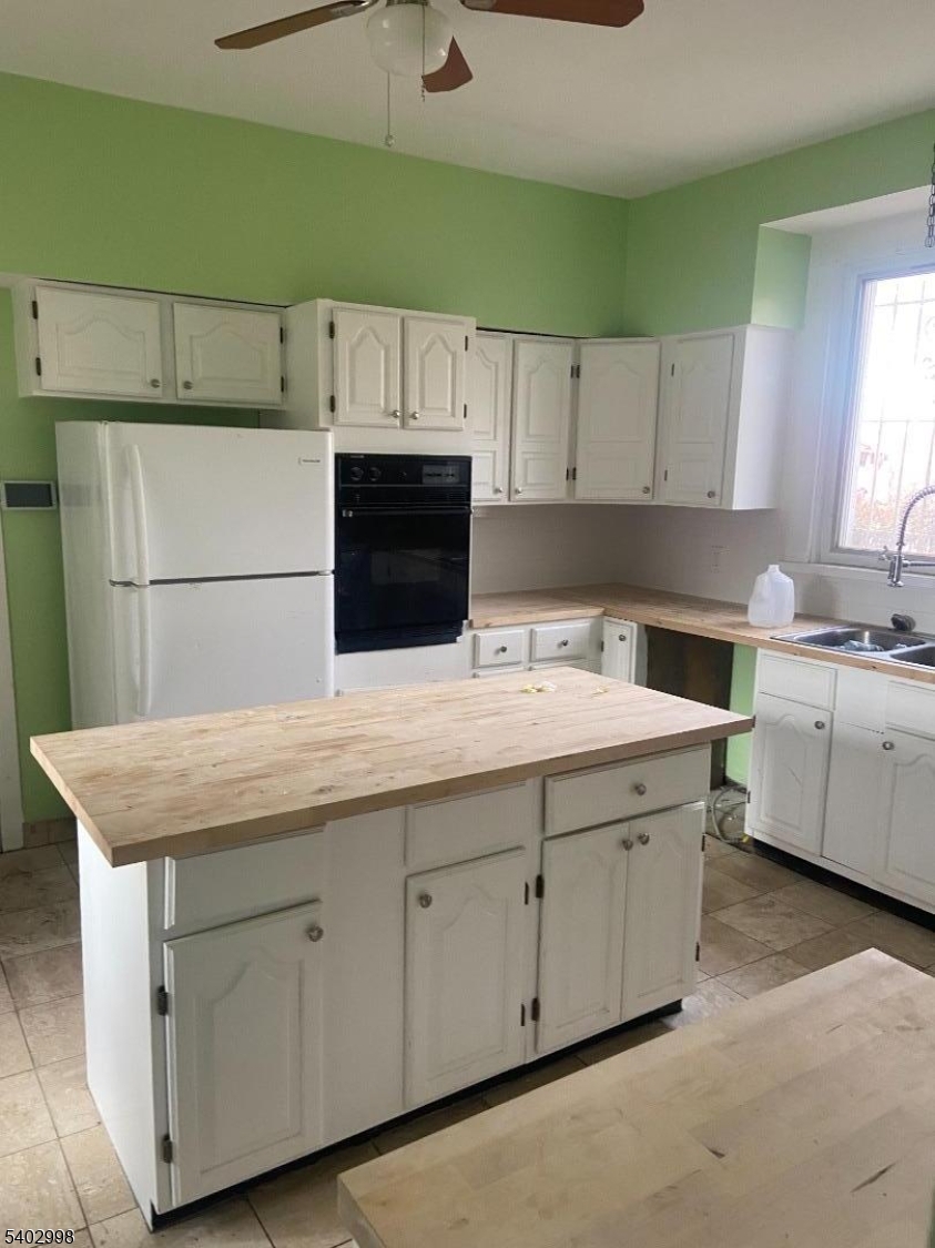 725 Elizabeth Avenue, Unit 2 Newark, NJ 07112 - Photo 3 of 8 a kitchen with cabinets and white appliances