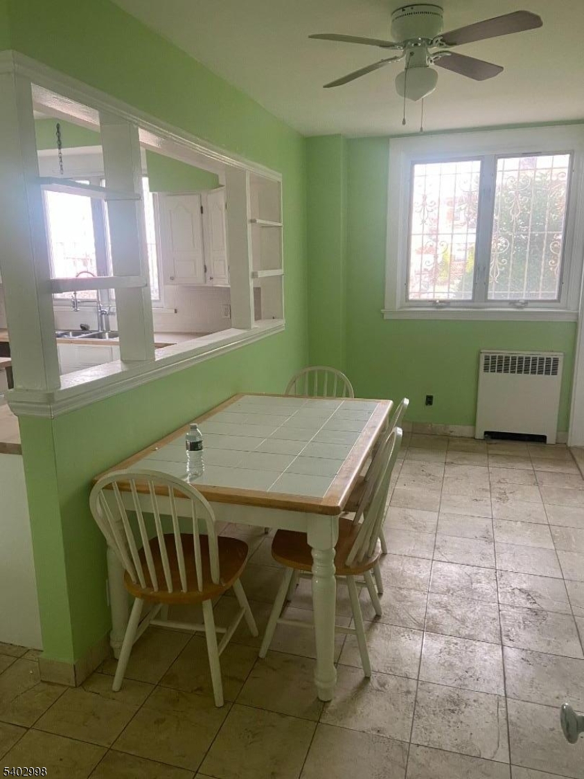 725 Elizabeth Avenue, Unit 2 Newark, NJ 07112 - Photo 5 of 8 a view of a dining room with furniture and window