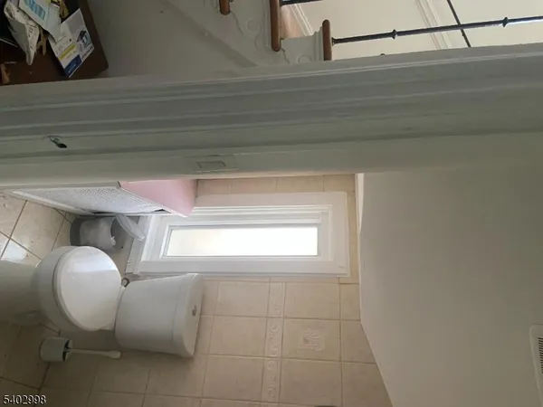 a bathroom with a mirror and a window