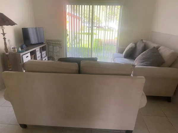 a living room with furniture and a window
