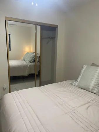 a bedroom with a bed and a mirror