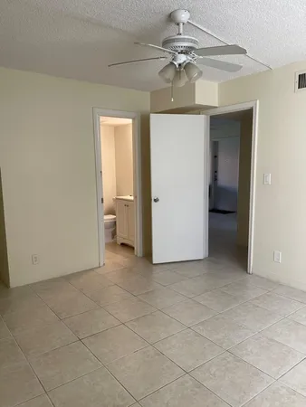 a view of a room with a ceiling fan and bathroom