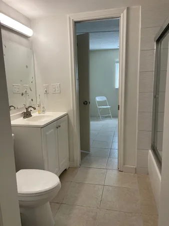 a bathroom with a toilet sink and shower