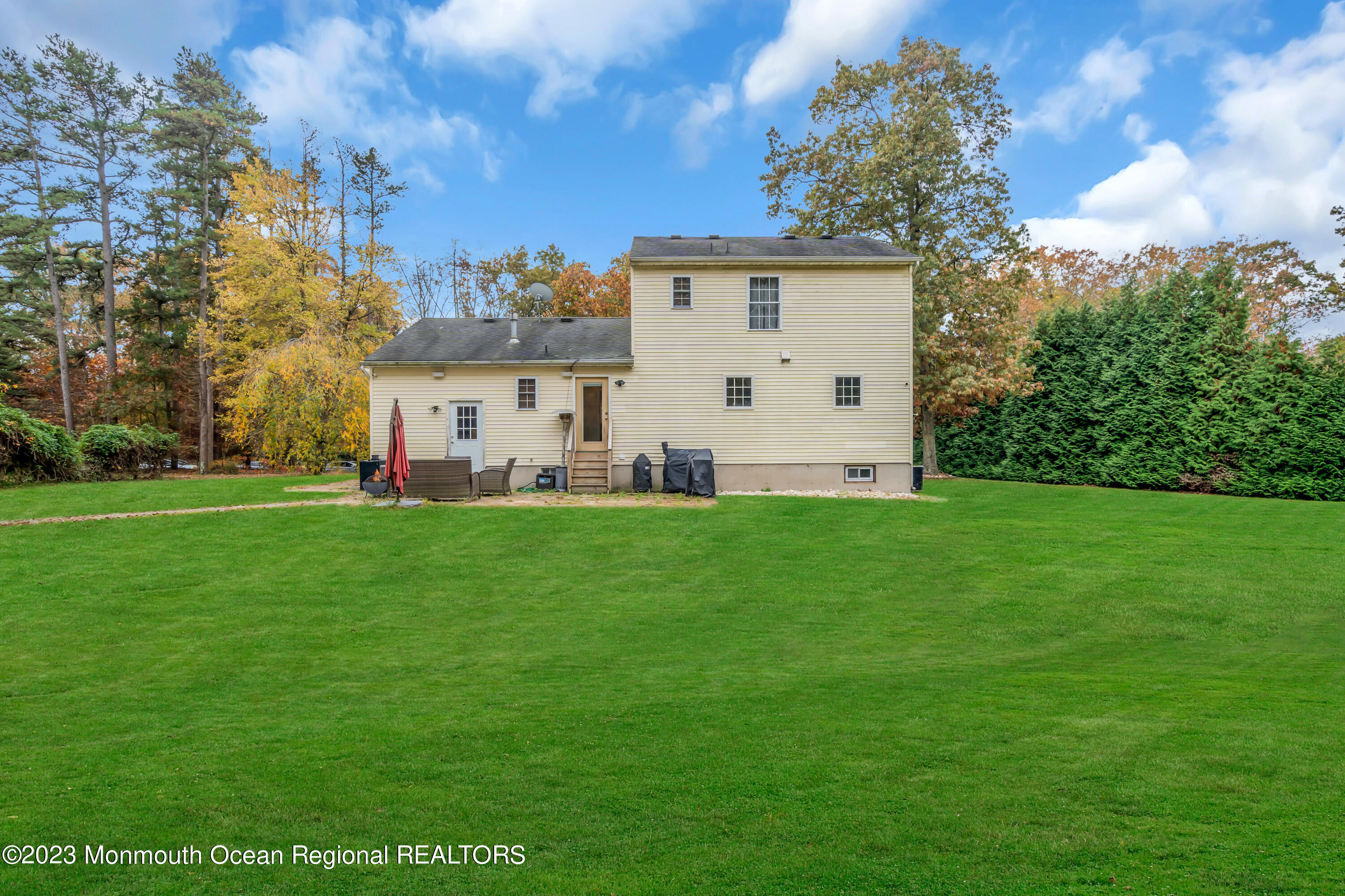 497 Leesville Road Jackson, NJ 08527 - Photo 23 of 25 a view of a white house with a big yard and large trees