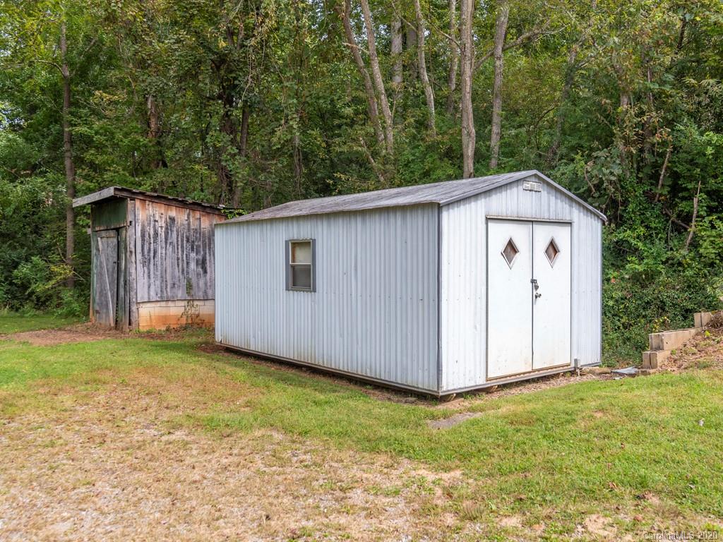 793 Morning Star Road Canton, NC 28716 - Photo 22 of 24 a view of a backyard with a garden and tree