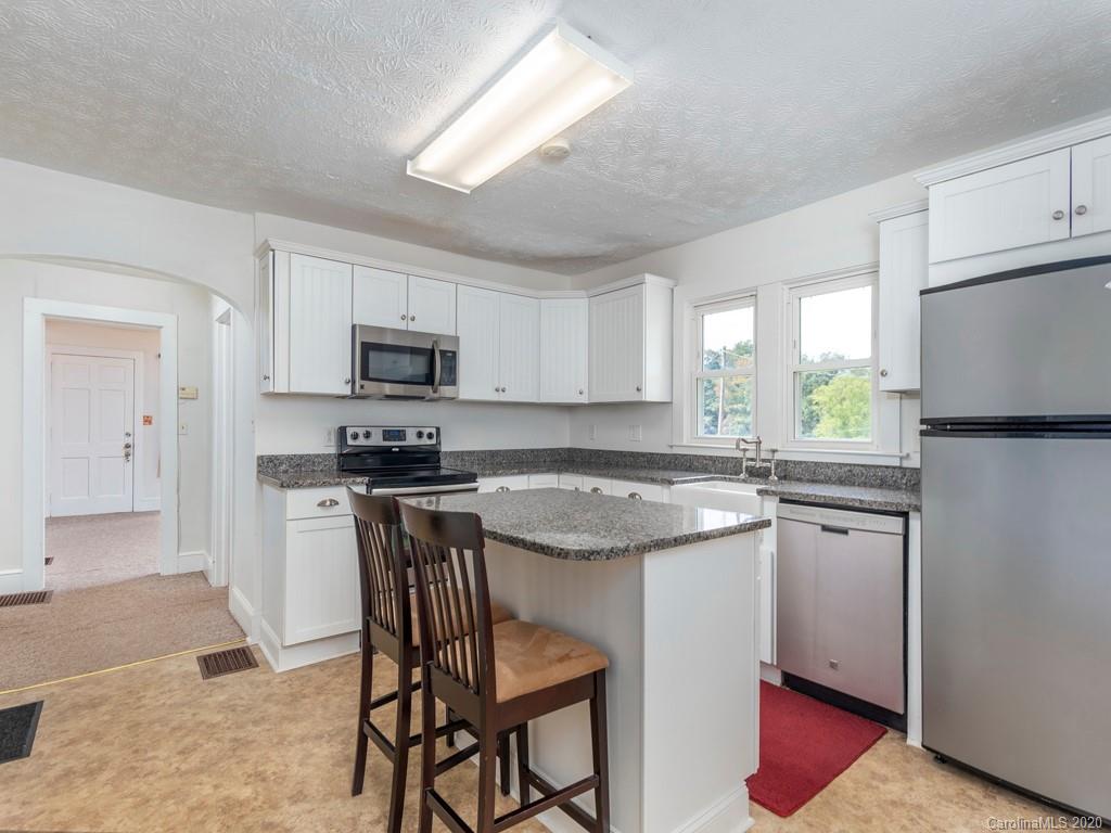 793 Morning Star Road Canton, NC 28716 - Photo 6 of 24 a kitchen with a stove a sink and a refrigerator