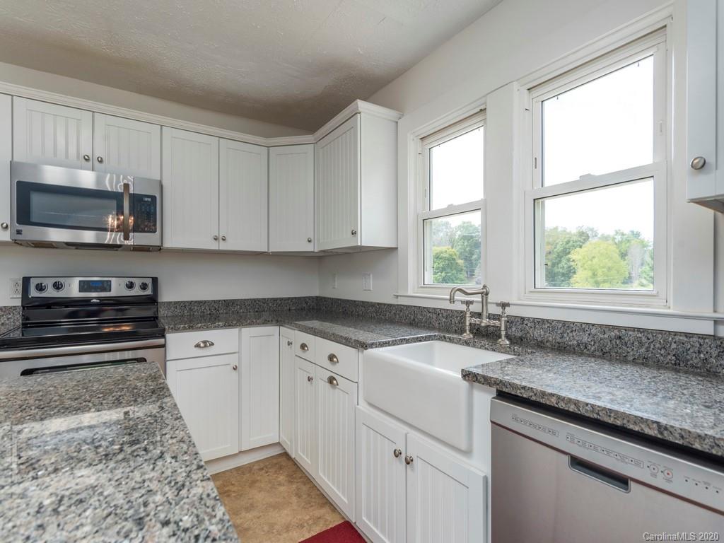 793 Morning Star Road Canton, NC 28716 - Photo 8 of 24 a kitchen with stainless steel appliances granite countertop a sink stove and microwave