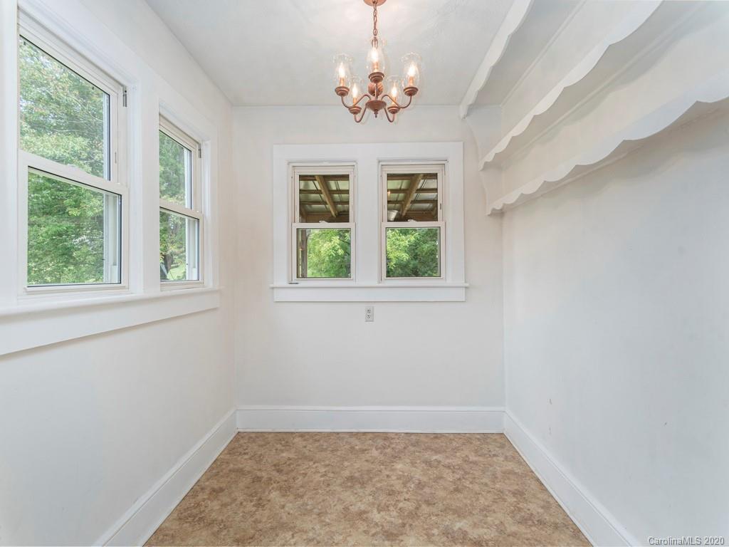 793 Morning Star Road Canton, NC 28716 - Photo 9 of 24 an empty room with windows and chandelier