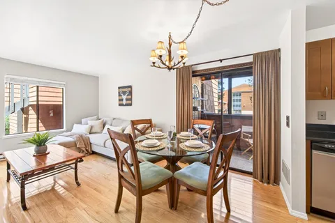a view of a dining room with furniture window and wooden floor