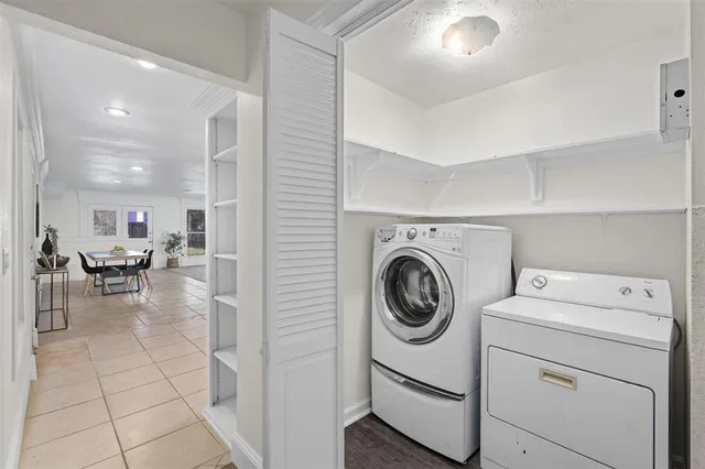 a view of washer and dryer with kitchen in the background