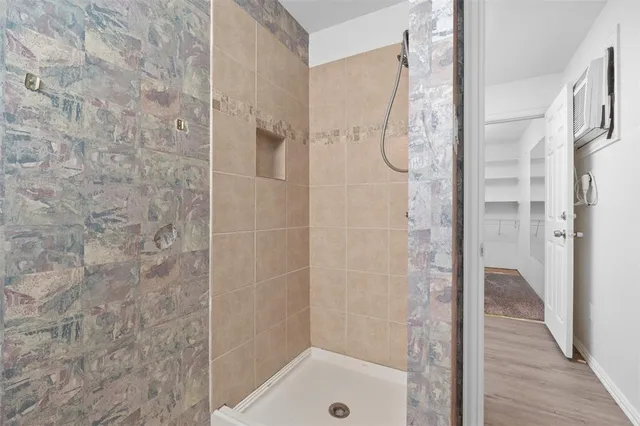 a bathroom with a glass shower door