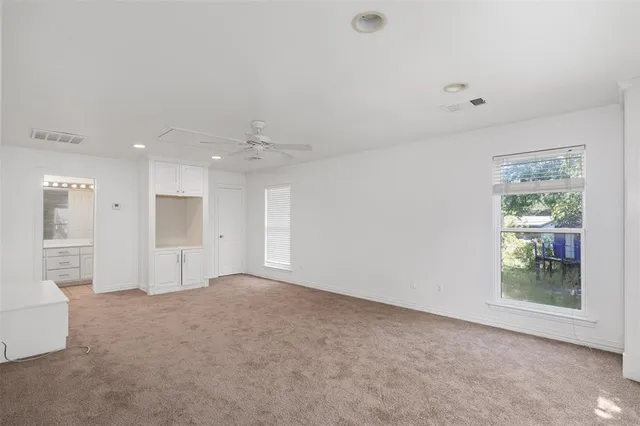 an empty room with windows and entrance