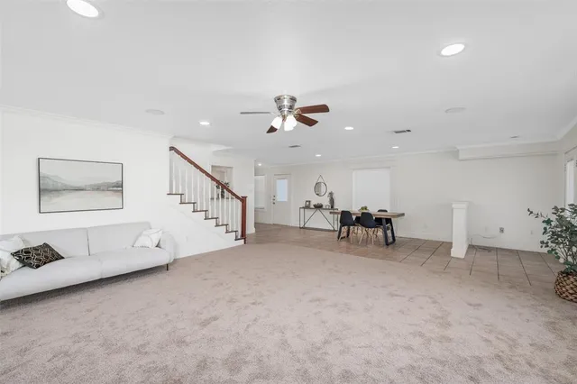 a view of a livingroom with furniture and a ceiling fan