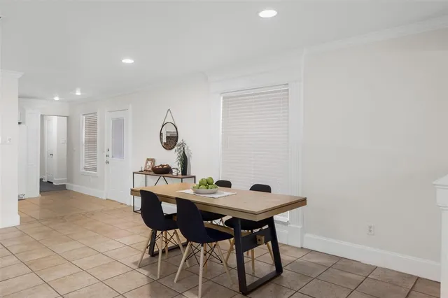 a view of a dining room with a table and chairs